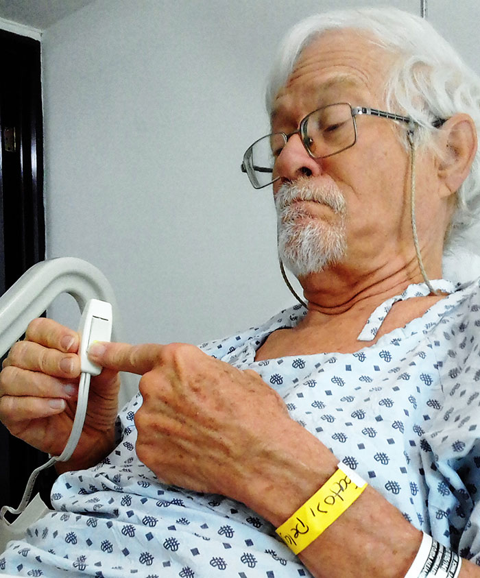 John Pint pressing emergency button in hospital