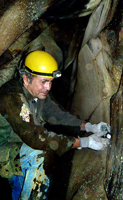 Luis Rojas using laser to map cave
