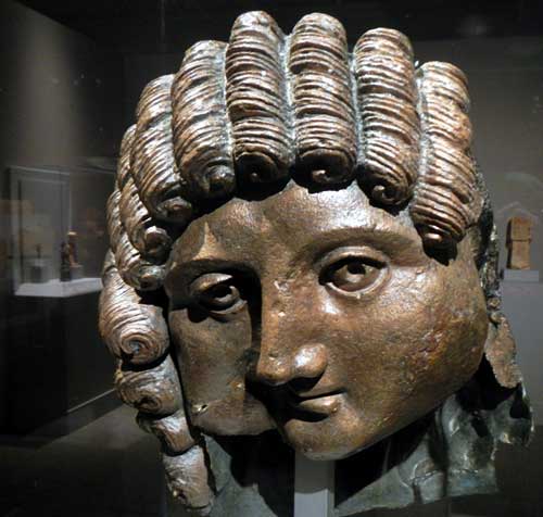 A cast bronze head, originally part of a life-size statue. The sensitive face recalls Greco-Roman models, while the curls are more typical of southern Arabian workmanship. It may be from the first or second century A.D. Photo by J. Pint